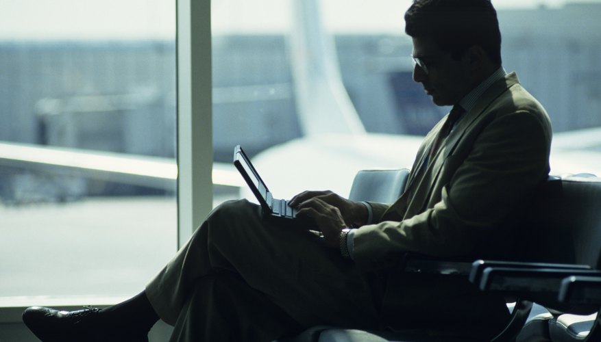 Businessman using laptop at airport