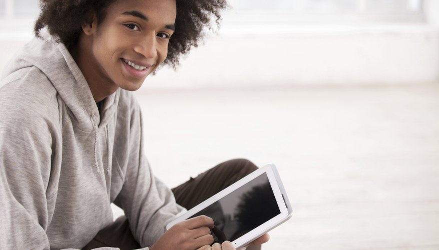 Smiling teenage boy holding tablet Smiling teenage boy holding tablet