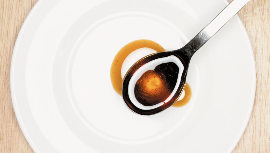 Amber color sorghum on a spoon. Amber color sorghum on a spoon.