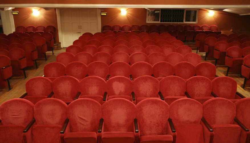 Photo Credit: Pavel Losevsky/iStock/Getty Images Old theater with worn red seats