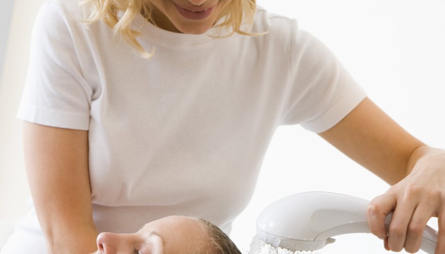Hairdresser shampooing woman's hair
