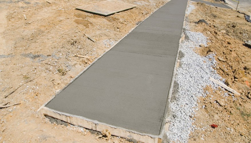 Wet cement sidewalk at construction site