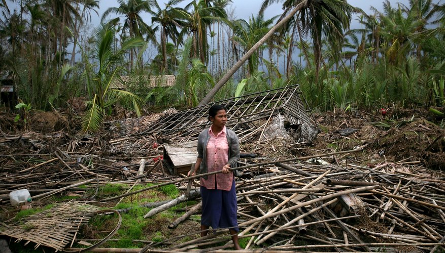 A woman picks through the wreckage of her home at the isolated village of Myasein Kan on May 20, 2008 in Myanmar. A woman picks through the wreckage of her home at the isolated village of Myasein Kan on May 20, 2008 in Myanmar.