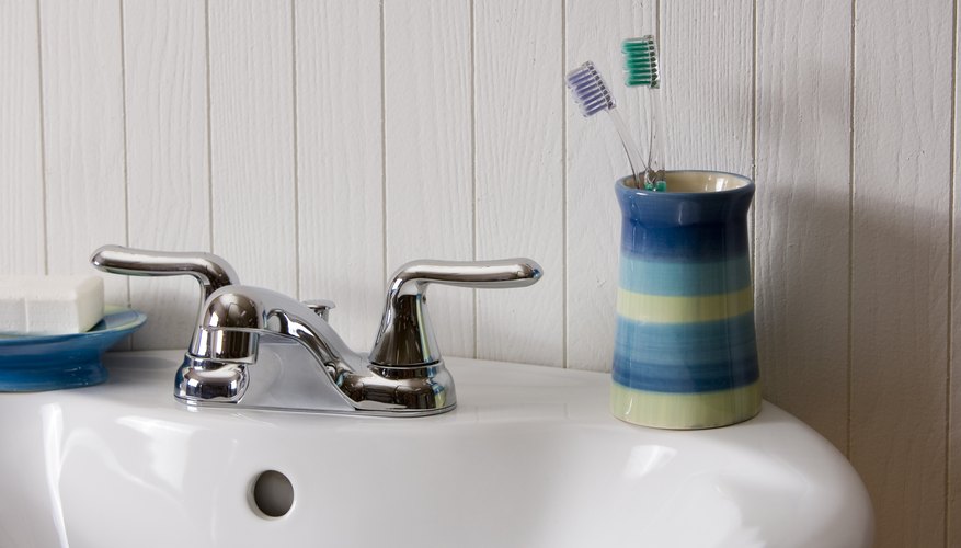 Toothbrushes on bathroom sink