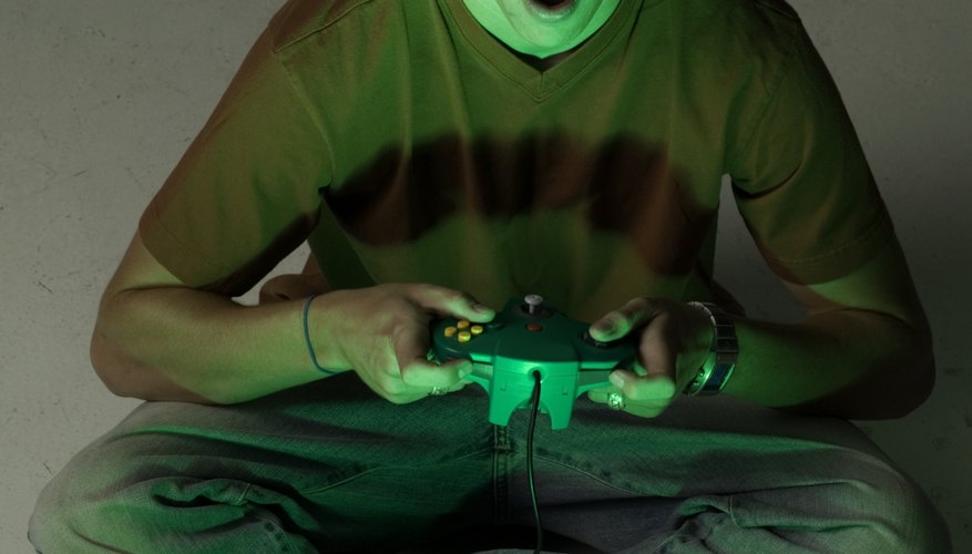 Young man sitting playing video games