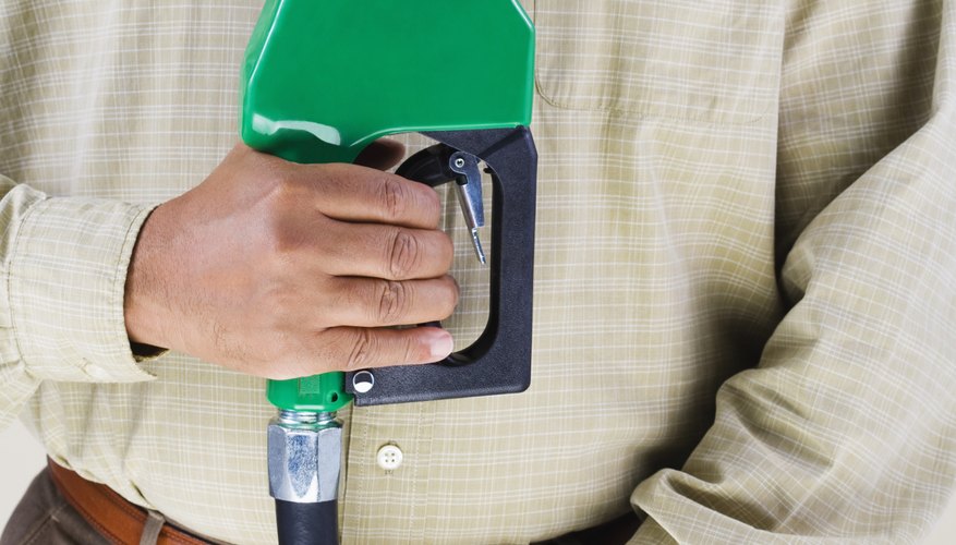 Man holding green fuel pump nozzle