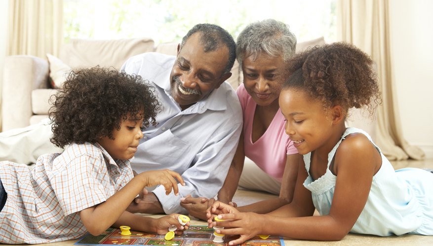 Grandparents playing board game with grandchildren Grandparents playing board game with grandchildren