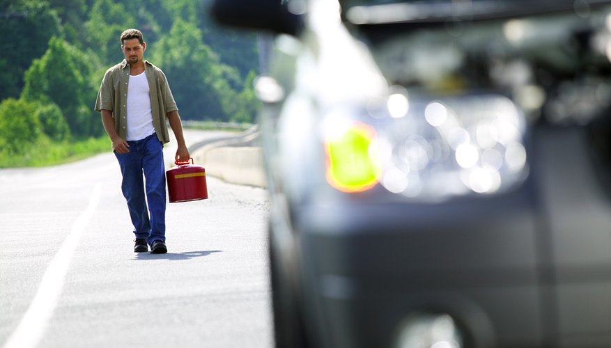 Man carrying gas can back to car