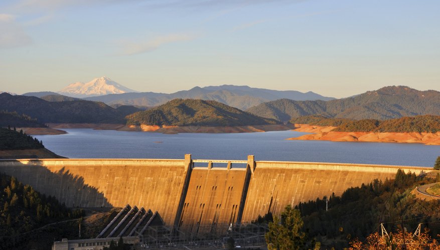 Photo Credit: Gary Whitton/iStock/Getty Images Shasta Dam with Mt. Shasta in the background
