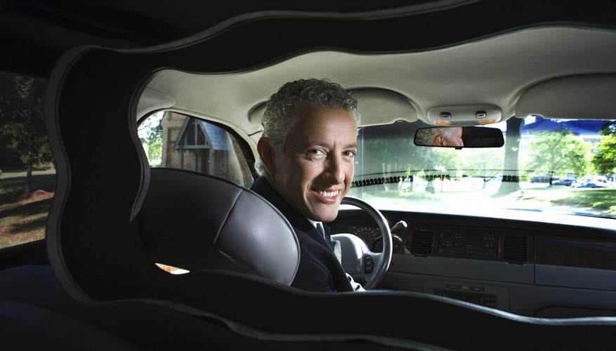 Chauffeur of limousine looking back