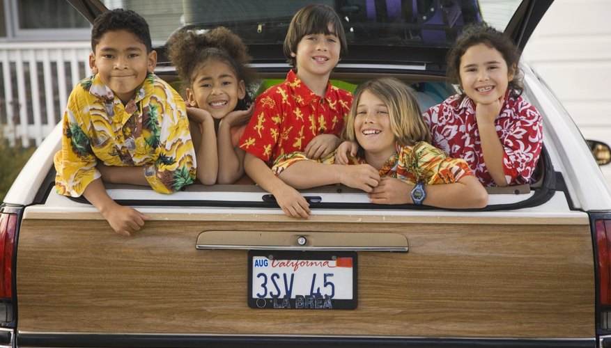 Five kids smiling in the back of a station wagon. Five kids smiling in the back of a station wagon.