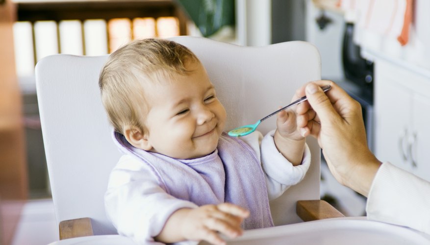 Baby smiling in highchair Baby smiling in highchair