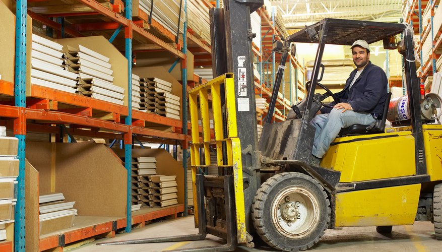 Warehouse worker posing in forklift