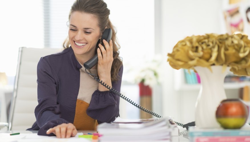 happy fashion designer talking phone in office