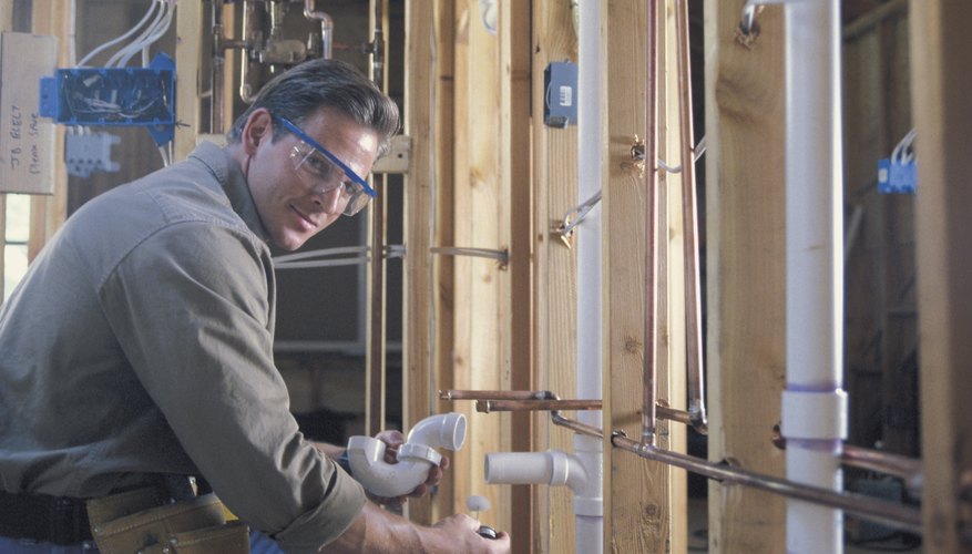 Plumber connecting pipes. Plumber connecting pipes.