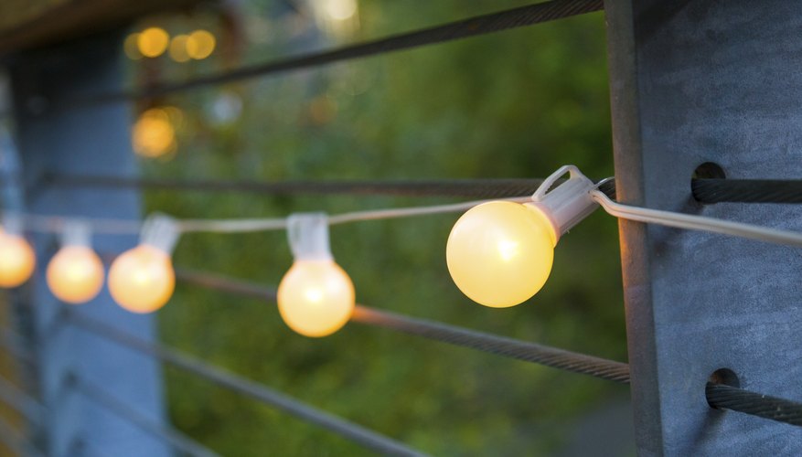 Strand of lights lit up on outdoor wall Strand of lights lit up on outdoor wall