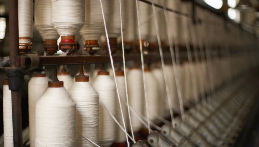 Spools of thread on machinery in textile mill
