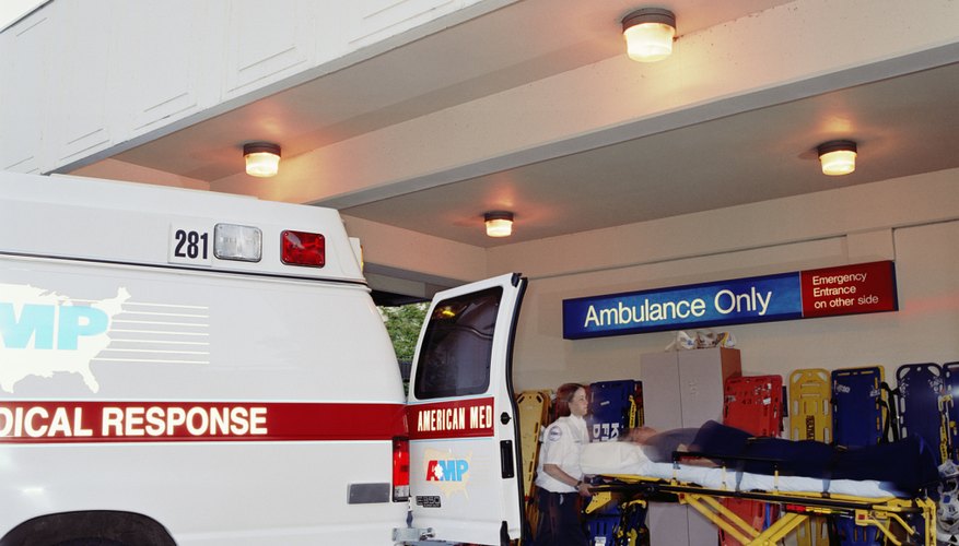 Paramedic transporting patient to emergency room from ambulance