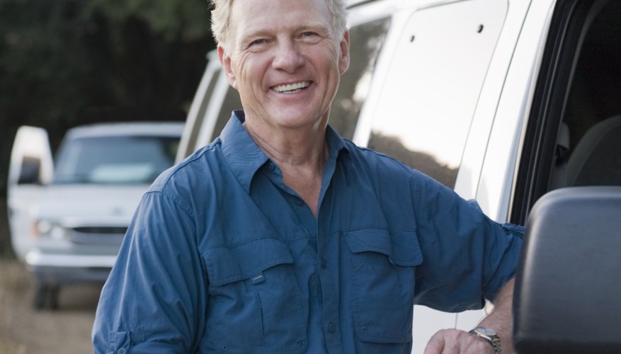 Portrait of smiling man next to a van
