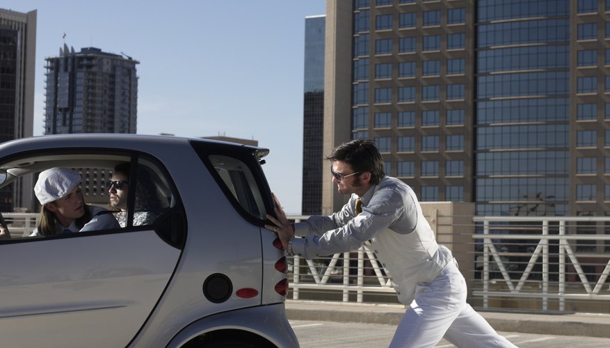 man pushing electric car