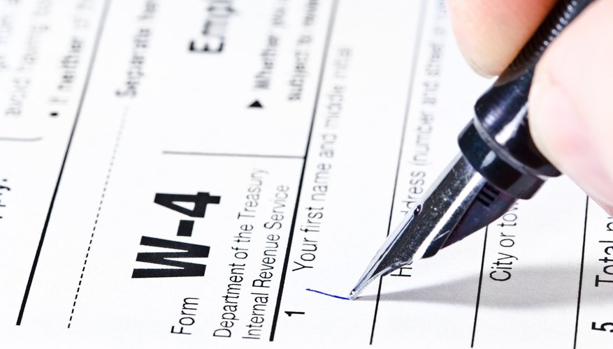 Pen writing on a W-4 form