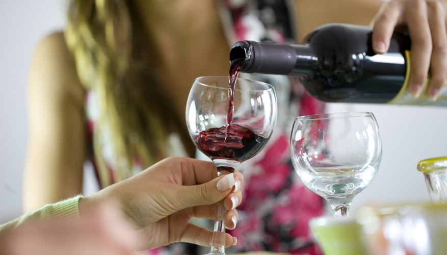 Woman pouring a glass of wine Woman pouring a glass of wine