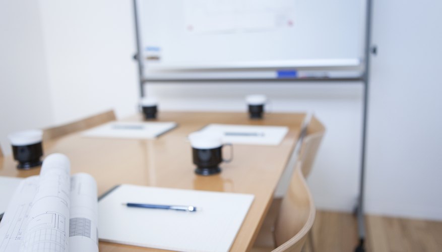 Whiteboard and table in empty board room