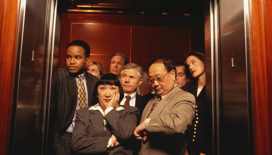 Businesspeople crowded in elevator, waiting