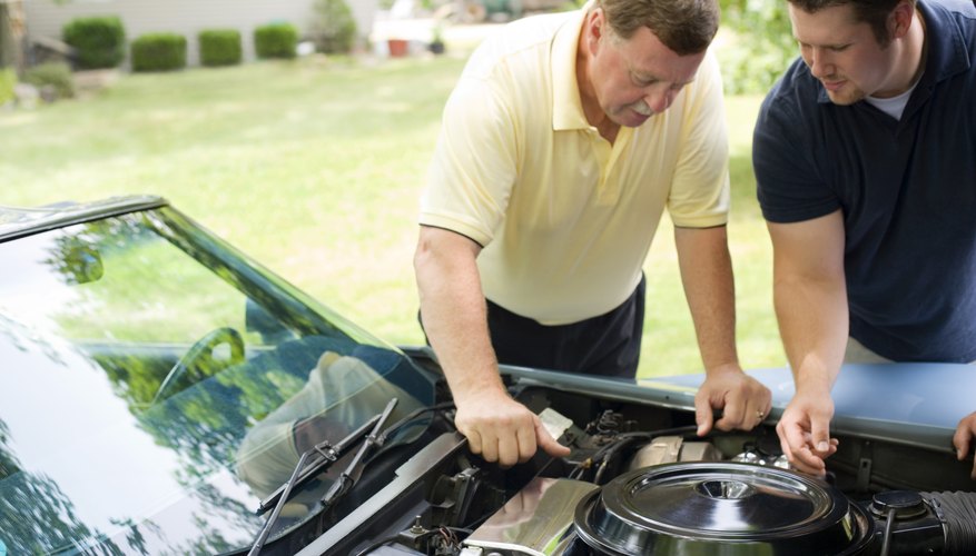 Father and son repairing car