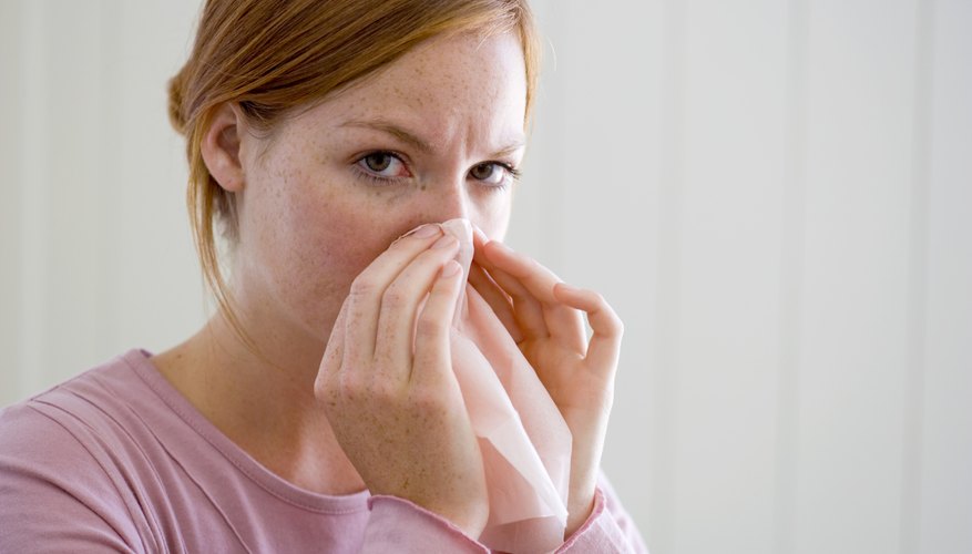 woman blowing nose woman blowing nose