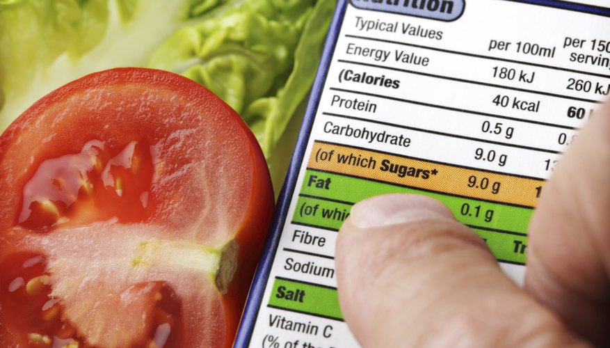 A man reads the nutritional label of a package. A man reads the nutritional label of a package.