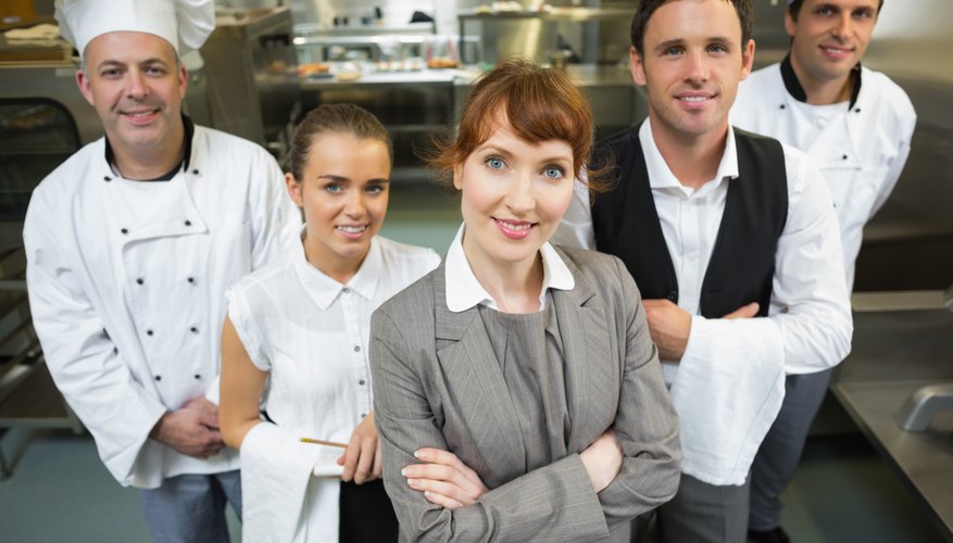 Cute female manager posing with the staff
