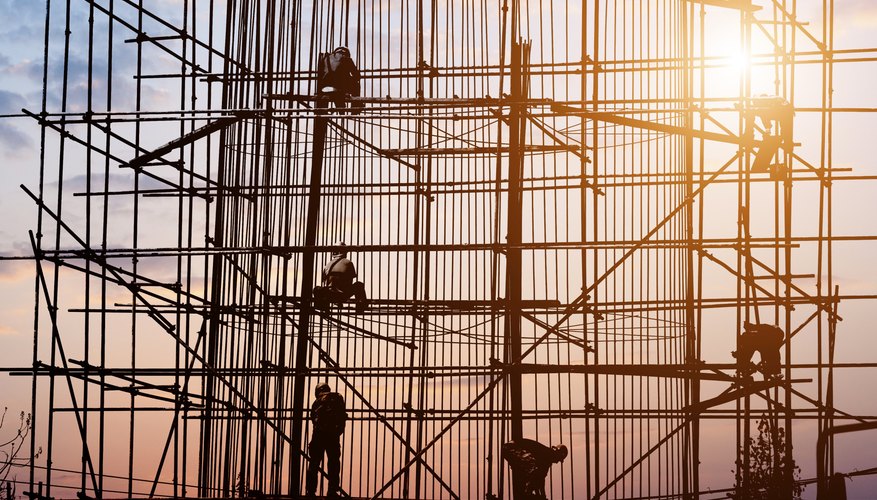 Photo Credit: hxdyl/iStock/Getty Images Specially trained workers on scaffolding