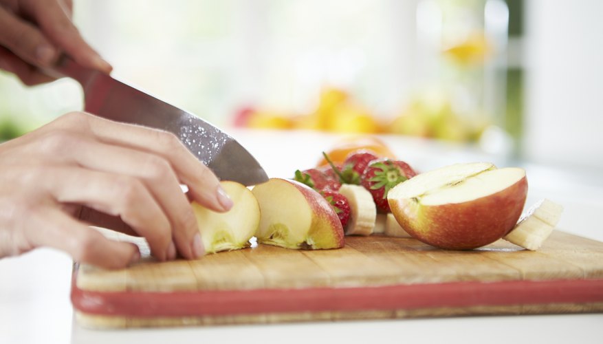 A woman cuts up a fresh apple. A woman cuts up a fresh apple.