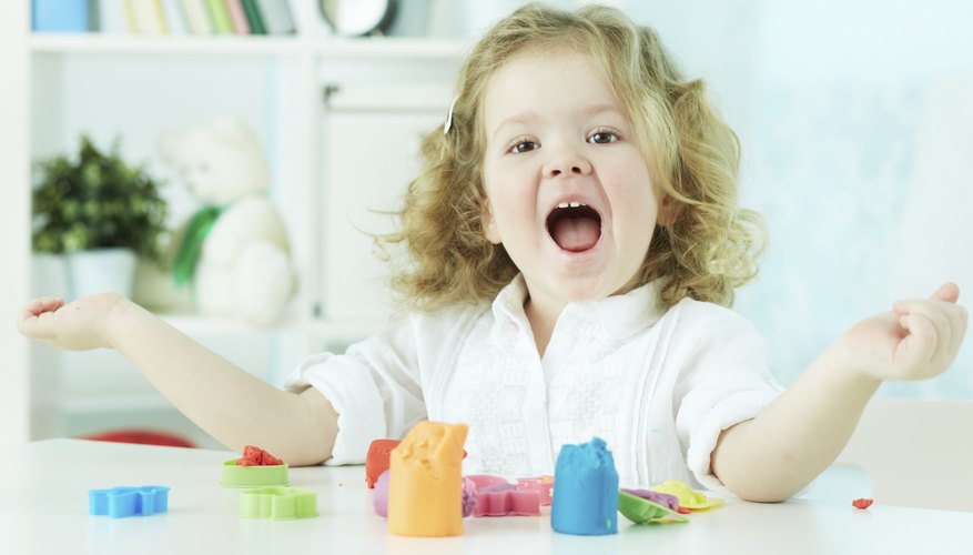 Happy child playing with Play-Doh. Happy child playing with Play-Doh.