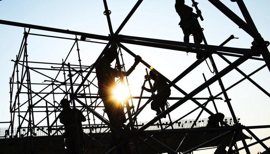 Photo Credit: hxdbzxy/iStock/Getty Images Workers on scaffolding platform