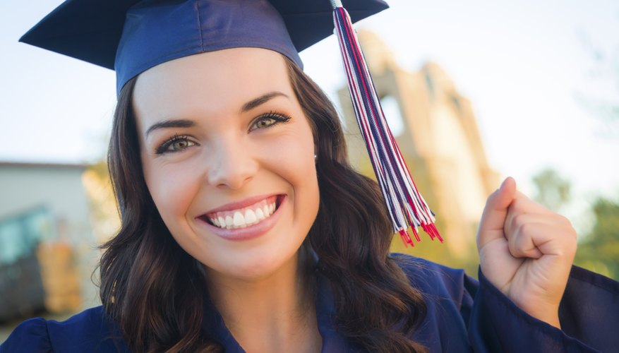 Smiling graduate student in cap and gown