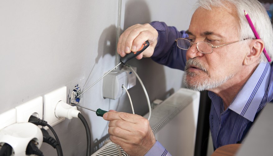 A close-up of an electrician at work.