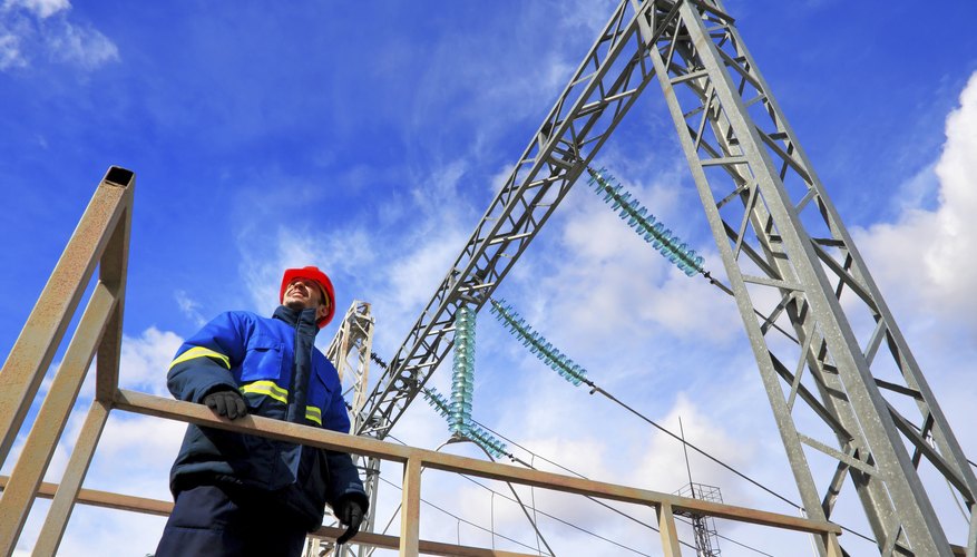 Photo Credit: Hramovnick/iStock/Getty Images A worker stands at a power plant.