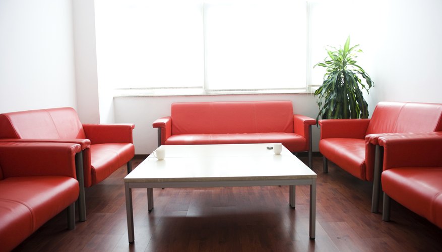 Photo Credit: hxdbzxy/iStock/Getty Images Meeting room with red leather couches