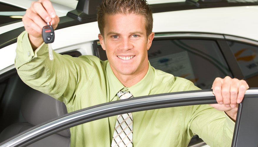 Car salesman posing with keys