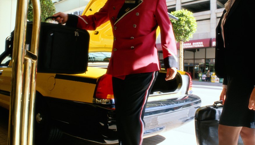 Bellhop Taking Businesswoman's Suitcases