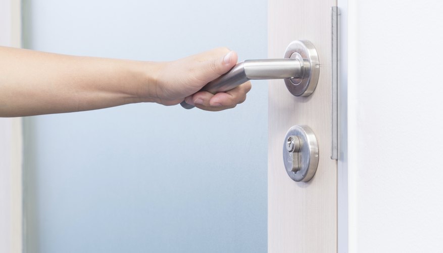 A woman grabs a door handle. A woman grabs a door handle.