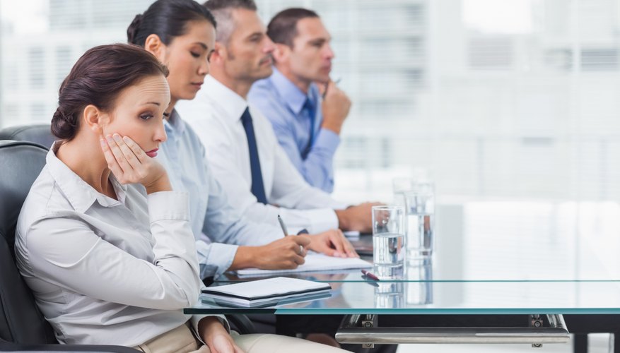 Businesswoman getting bored while attending presentation