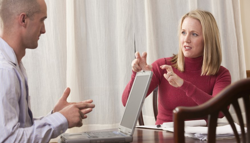 Woman and man signing the phrase 'Pay and Investment' in American Sign Language
