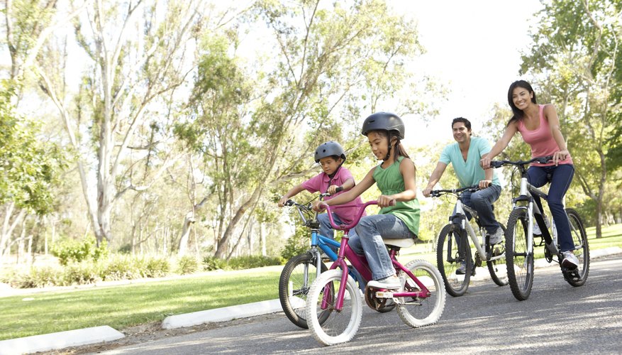 Photo Credit: monkeybusinessimages/iStock/Getty Images A family riding bikes together