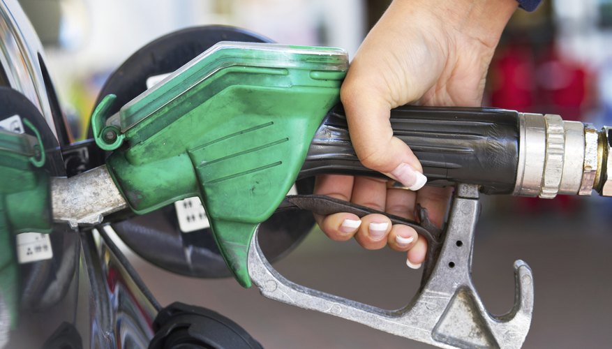 Photo Credit: Patryk Kosmider/iStock/Getty Images A woman refuels her car with gasoline.