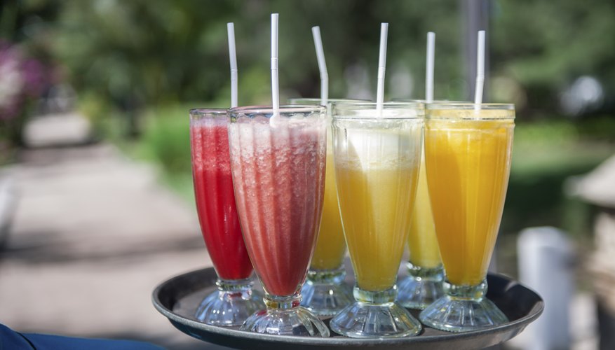 An assortment of fruity cocktails on a tray. An assortment of fruity cocktails on a tray.