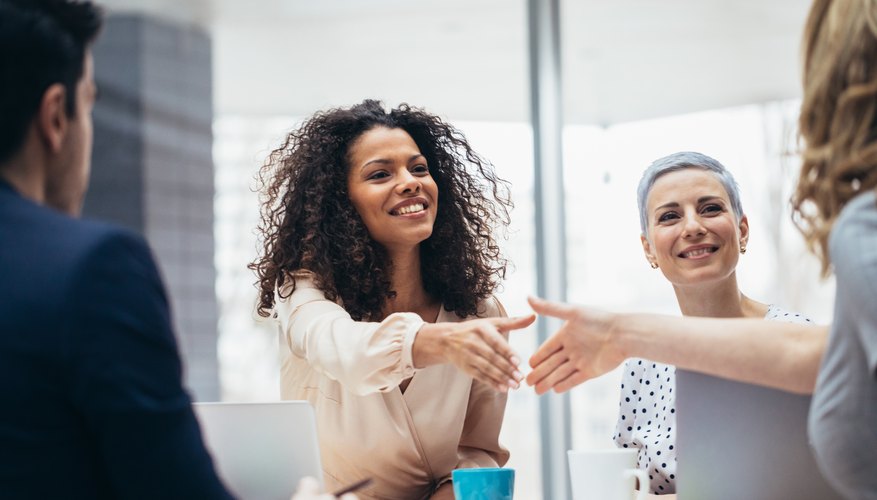 Businesswomen shaking hands at the office