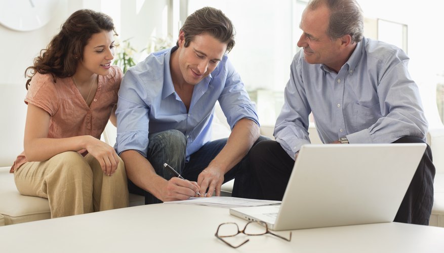 Couple signing papers with financial advisor